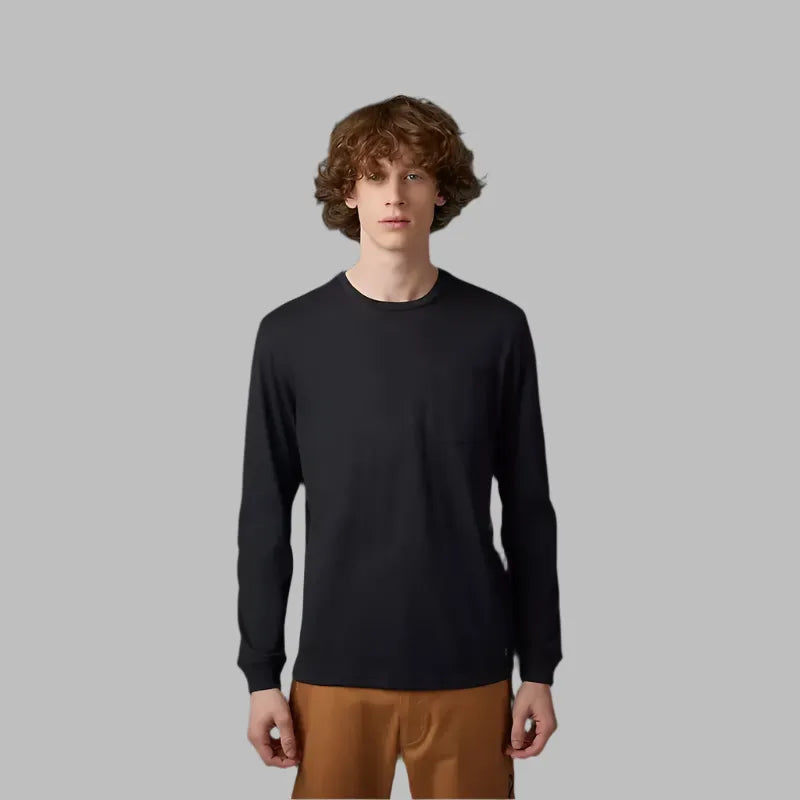 FOX® HEAD Level Up Long Sleeve Pocket Tee in black, modeled by a person wearing brown pants.